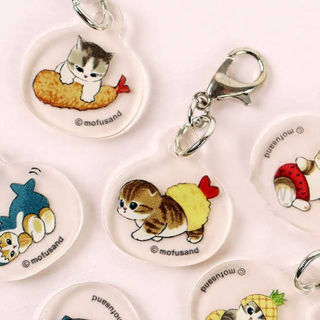 The Mofusand Mini Keychain Charm 2 Piece Set features clear acrylic charms of cats as sushi and shrimp, each with a metal lobster clasp—adorable Mofusand brand accessories to add a cute accent to your bag or keys.