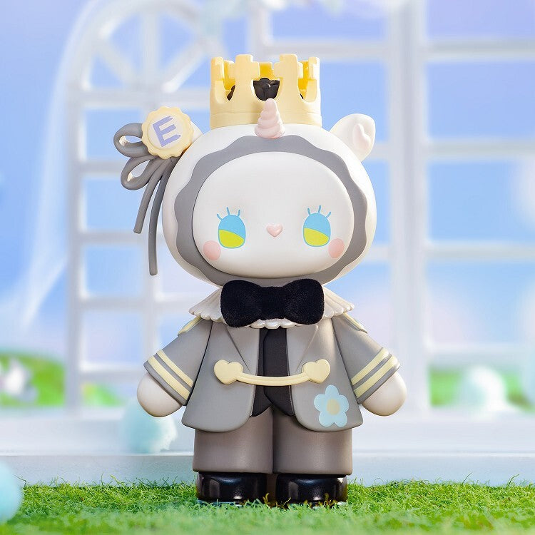 The Lucky Emma Secret Forest Wedding Blind Box figure by Lucky Emma features a unicorn horn, yellow crown, gray outfit, black bowtie, and blue-yellow eyes—an adorable collectible for fans seeking unique surprises.