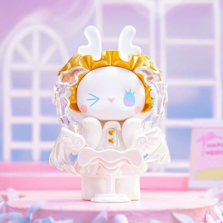 A hand-painted white rabbit in a gold headdress and frilled outfit stands on pink before pastel arched windows, capturing the charm of the Lucky Emma Secret Forest Wedding - Blind Box collectible by Lucky Emma.