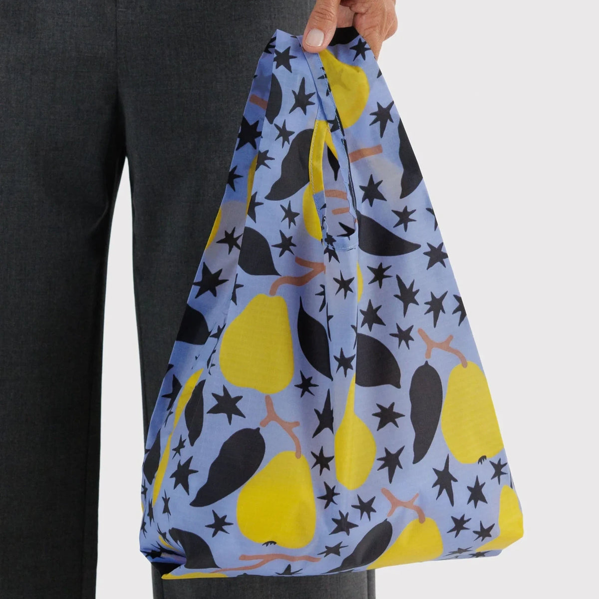 Baby Baggu tote bag held open, blue with yellow pear and star print