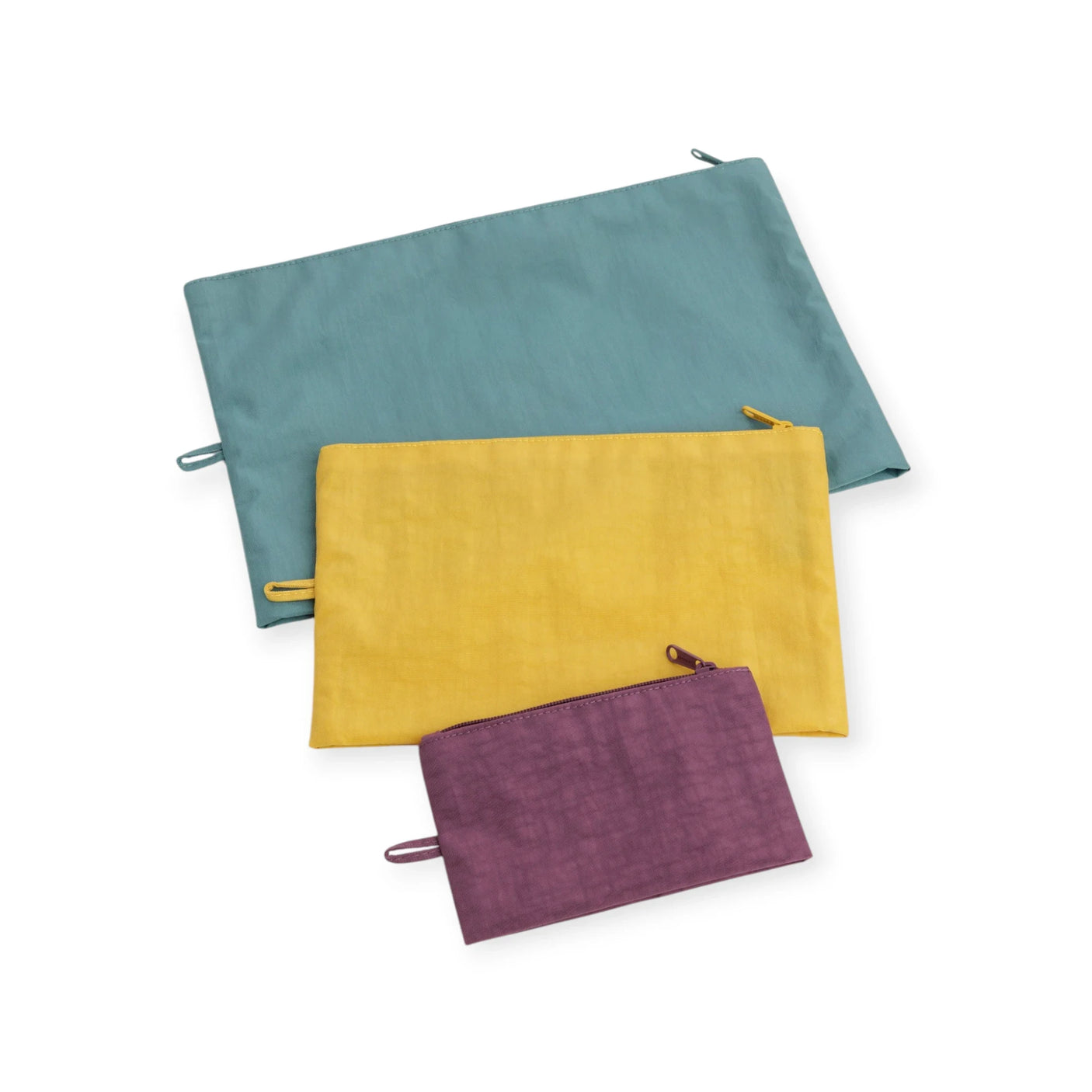 Three canvas zipper pouches in teal, yellow, and plum, stacked in a set.