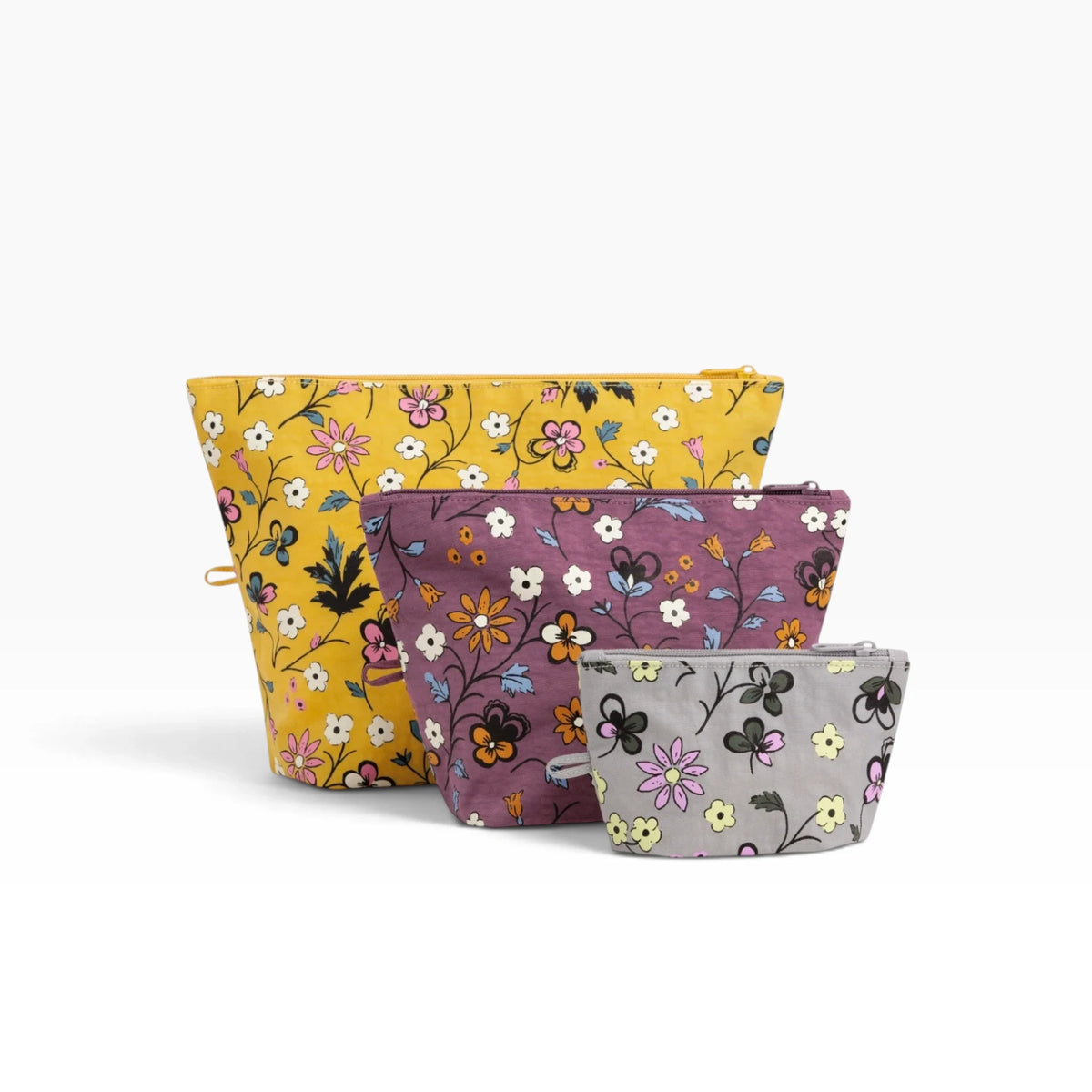 Baggu Go pouch set with three floral zip pouches: yellow, purple, and light gray