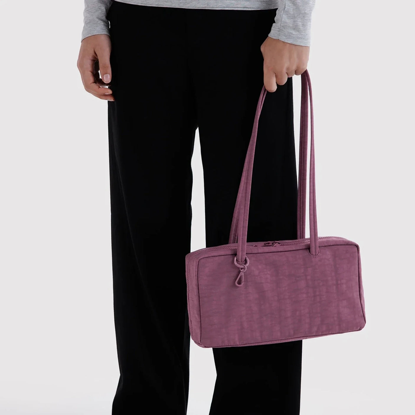 Plum nylon bowler bag with top handles and zip closure, side view