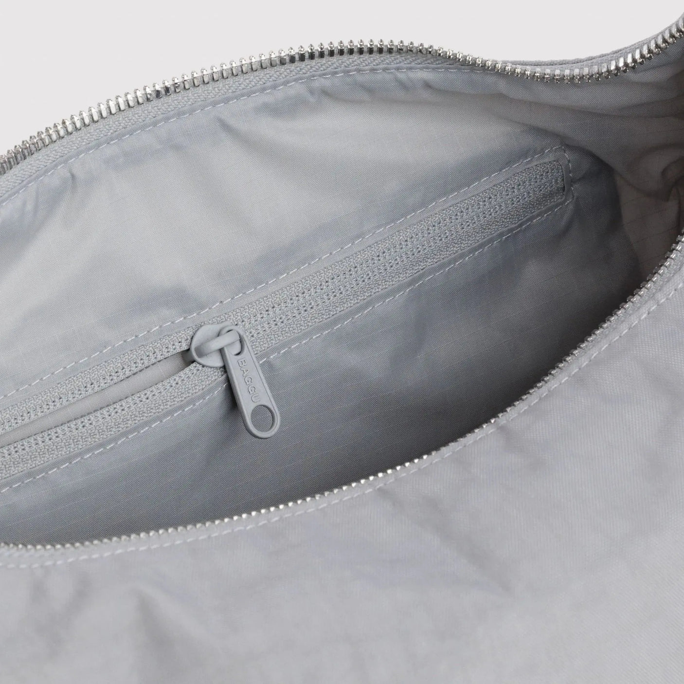 Nylon tote bag interior with zipper and fabric lining, gray zipper pull