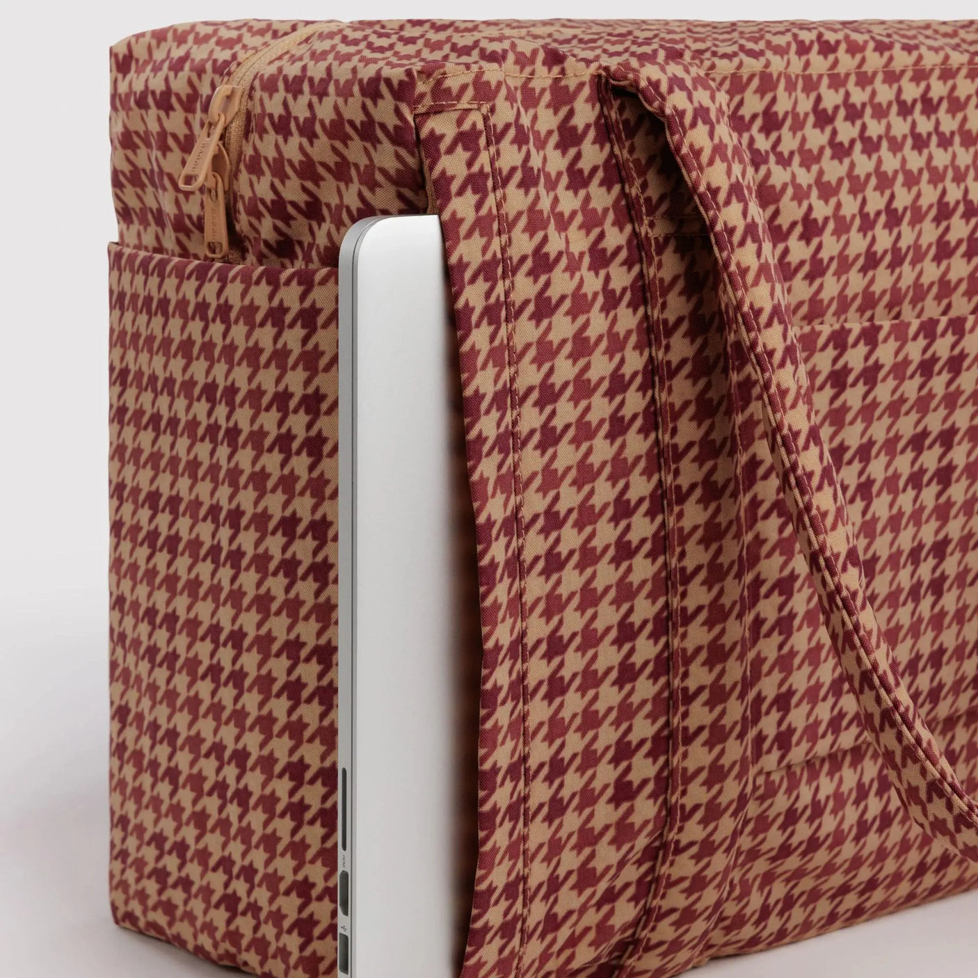 Houndstooth carry-on bag side view with zipper, tan and dark red pattern
