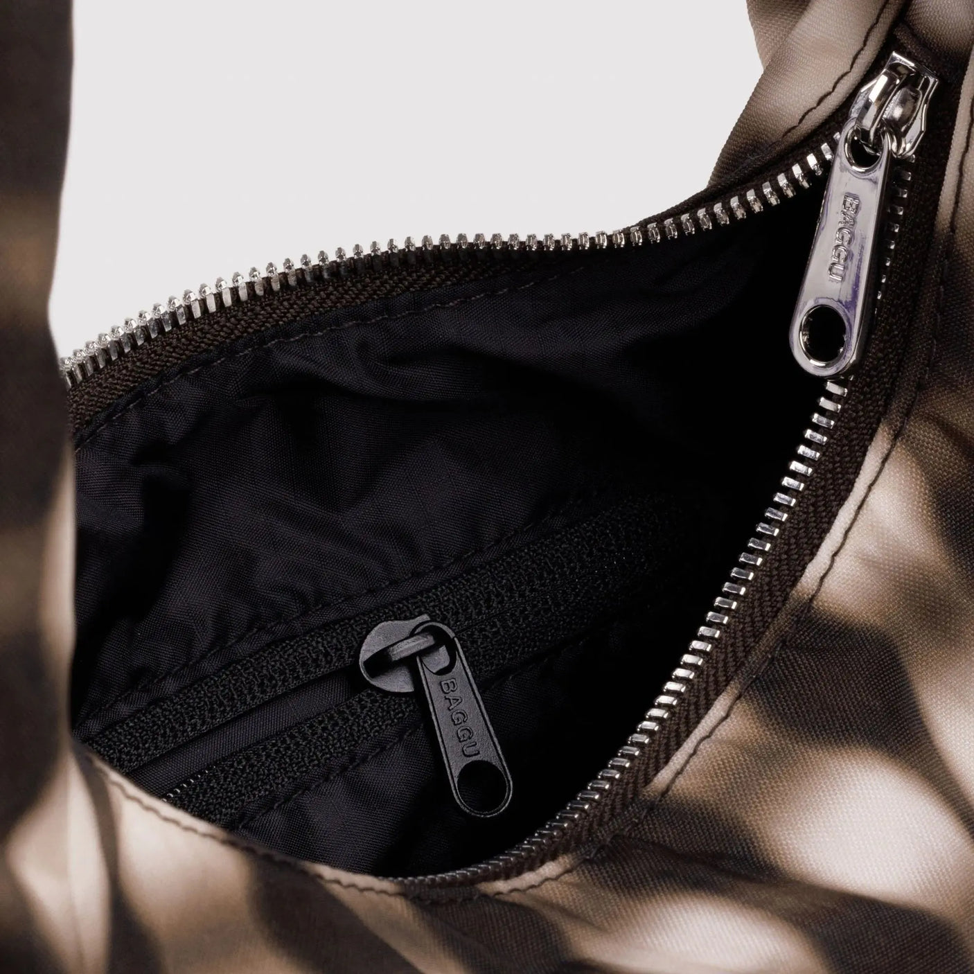 Small nylon bag interior with black zipper pocket and silver zipper pull