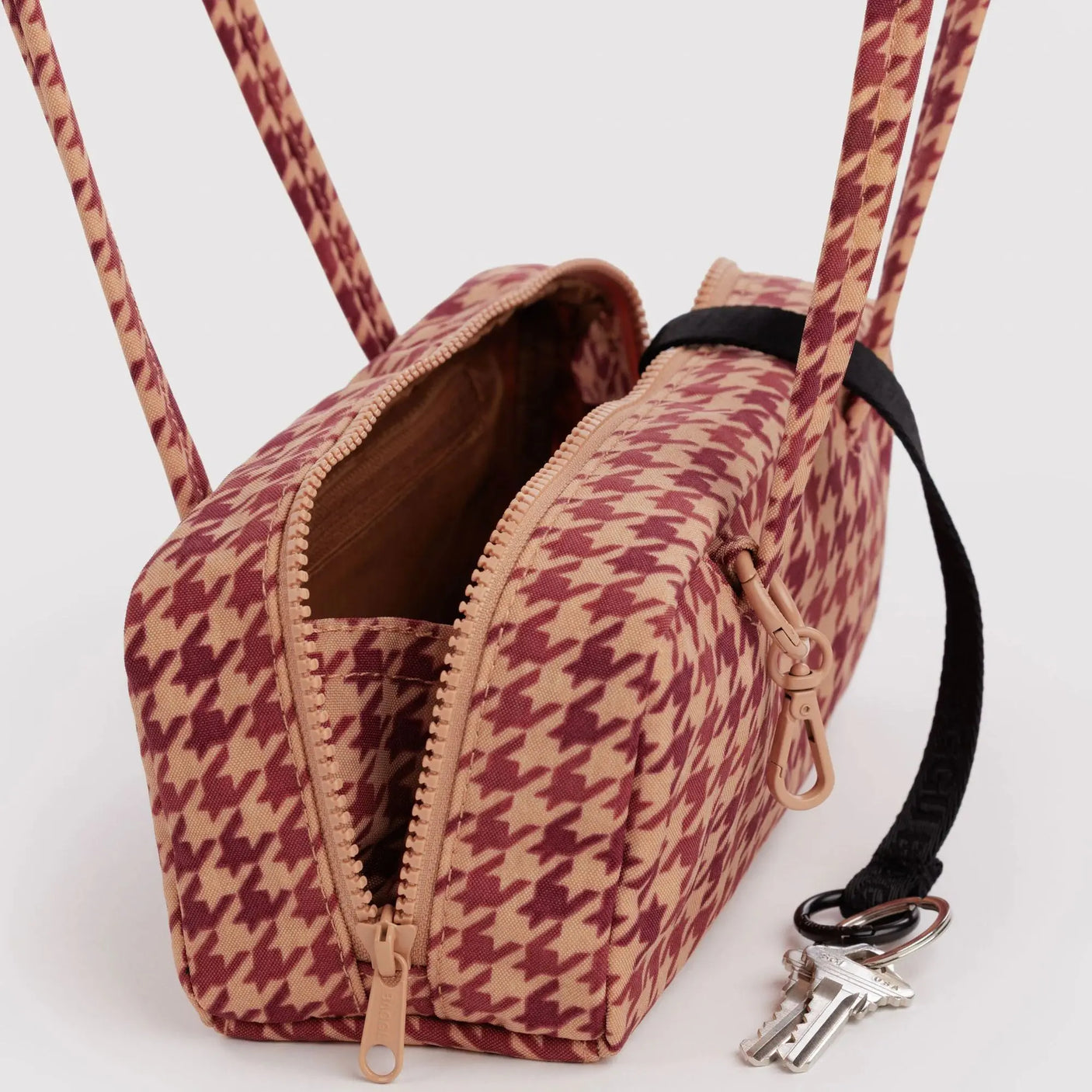 Small houndstooth bowler bag open with zipper, tan and burgundy interior