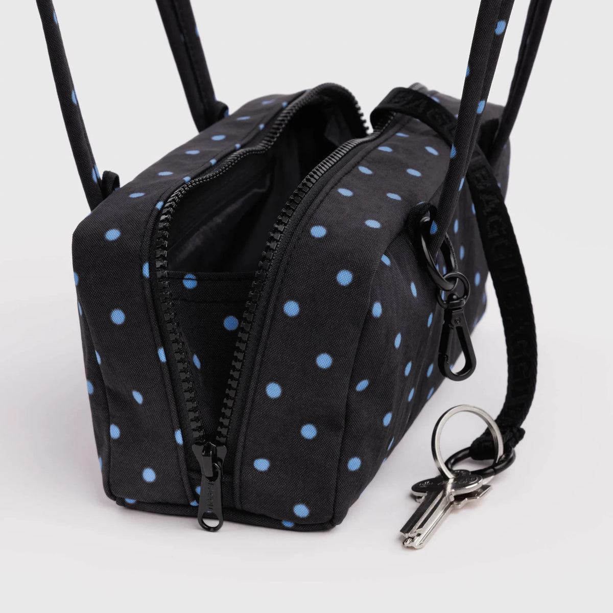 Small bowler bag with micro dot fabric, front zip pockets, key ring and strap details