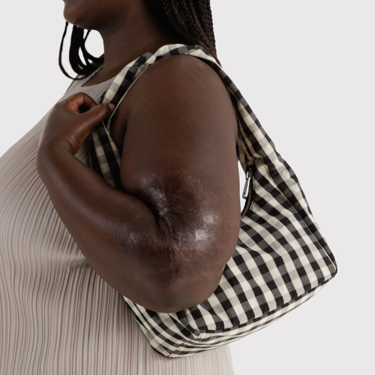 Gingham nylon bag worn over shoulder with short handles