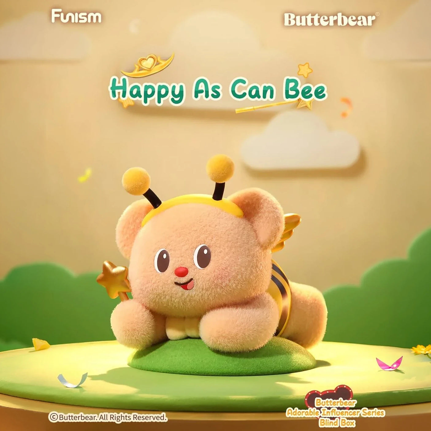 Plush bear dressed as a bee with antennae and wings lying on green surface with soft background clouds and hills