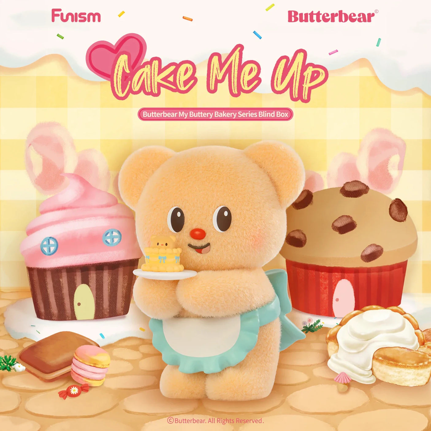 Soft plush bear in blue apron holding tiny cake with cupcake and cookie house background in pastel tones