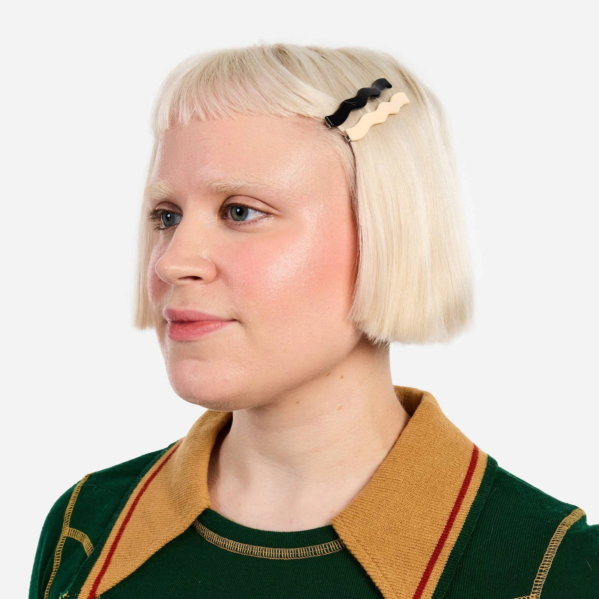 Black wavy hair slide clip securing blonde hair at the side