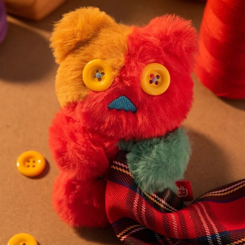 Plush figure from Finding Unicorn Shinwoo Cold Hugs Blind Box with multicolored fur and large yellow button eyes on beige surface