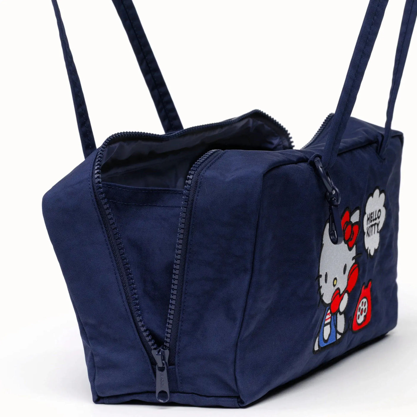 Navy nylon bowler bag side view with zipper seam and Hello Kitty graphic