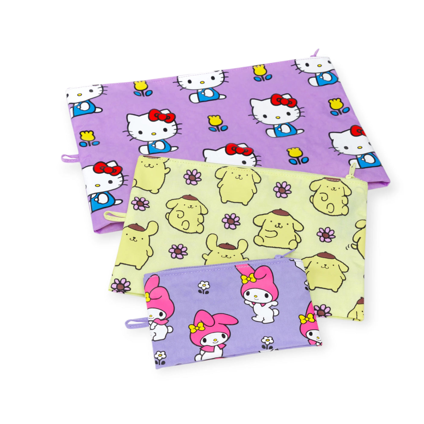 The Hello Kitty x Baggu Go Pouch Set by Baggu features three zippered pouches with Hello Kitty, Pompompurin, and My Melody designs in purple, yellow, and lavender, arranged overlapping on a white background—perfect for Sanrio fans.