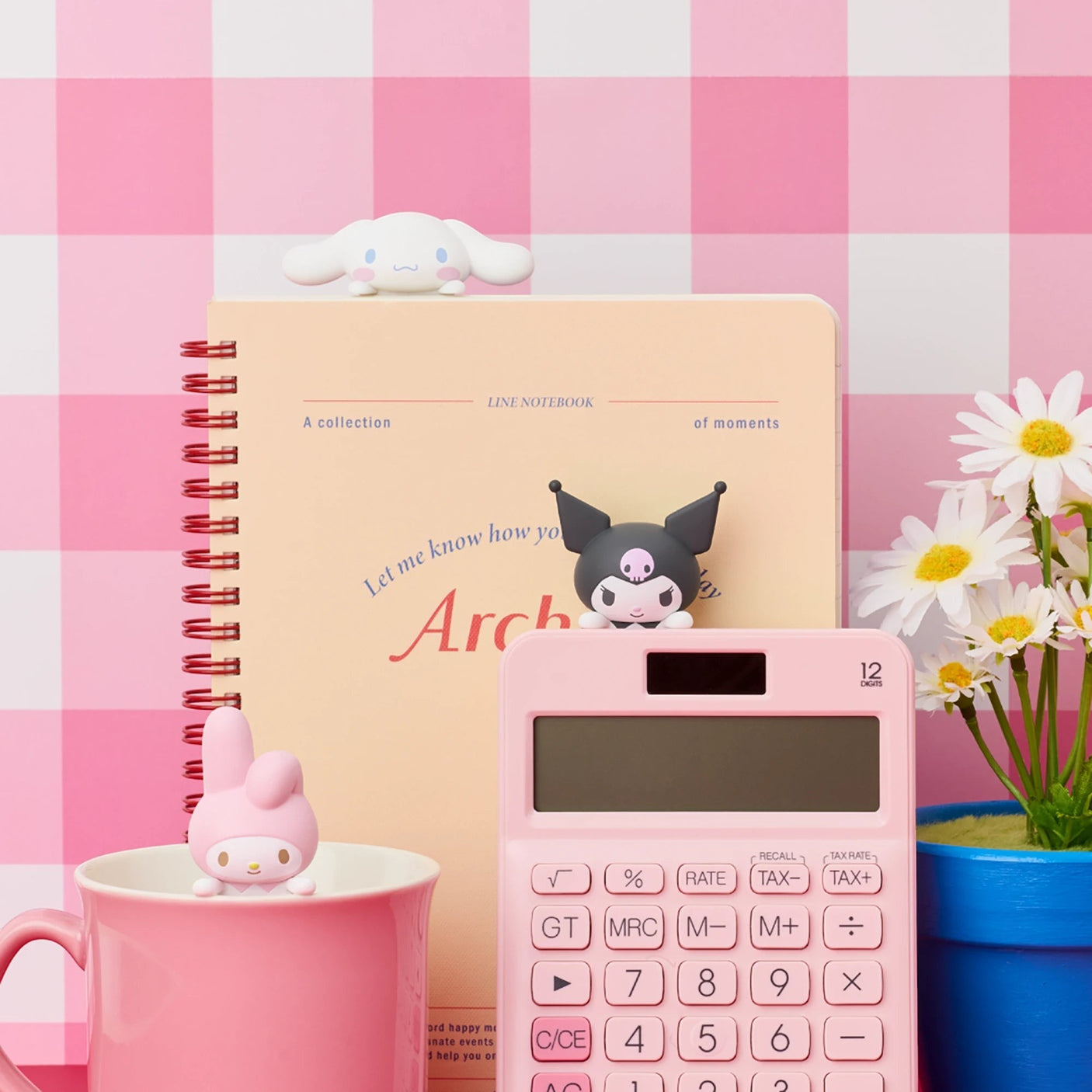 Hello Kitty Hippers mini figures beside notebook and calculator