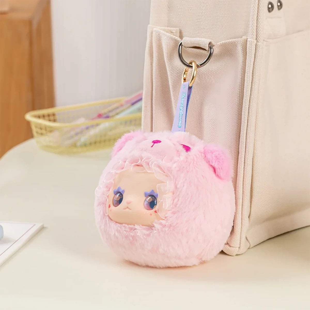 Pink fluffy plush Lovely Emma Rua Rua Zoo bag charm keychain attached to beige canvas bag pocket