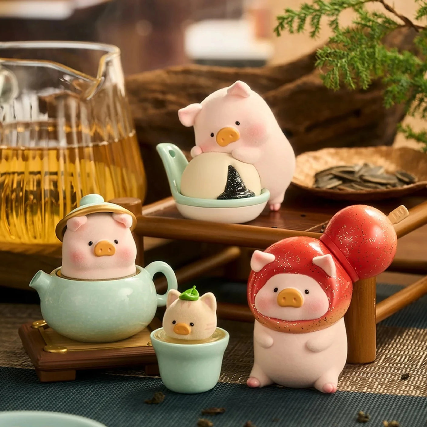 Pig chef toy figurines with kettle, small bowl, and food pieces on a tabletop