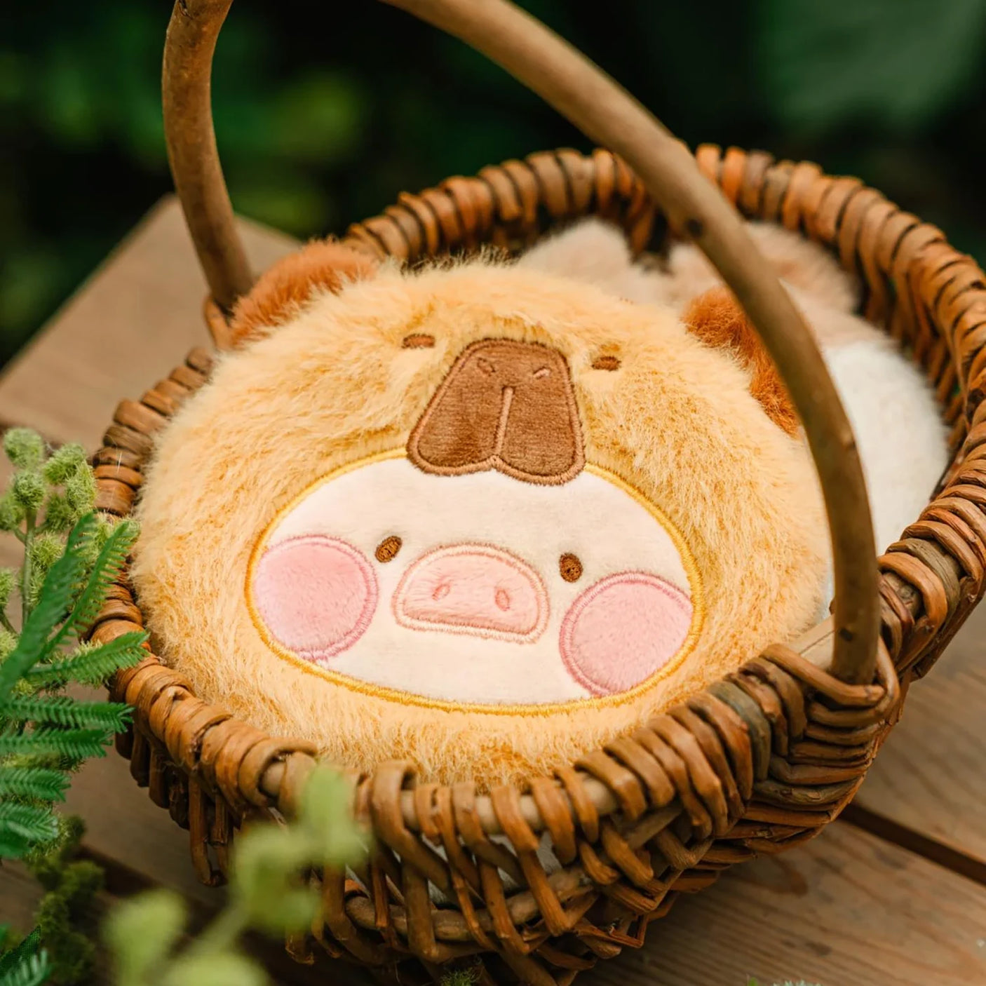 Soft LuLu The Piggy pouch with capybara face design inside a woven basket, Animal Party collection, gallery position 1