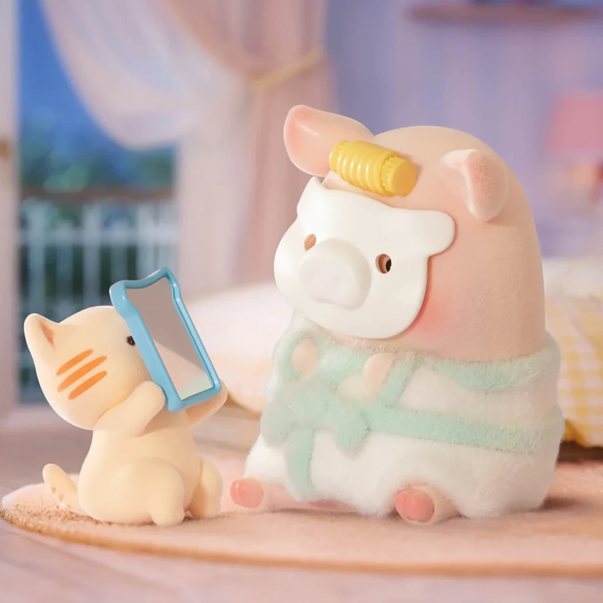 A small cat figurine holds a mirror for LuLu the Piggy, who wears a facial mask and towel on a soft surface in a pastel room—an adorable collectible from the LuLu The Piggy - Stay With You Blind Box series.