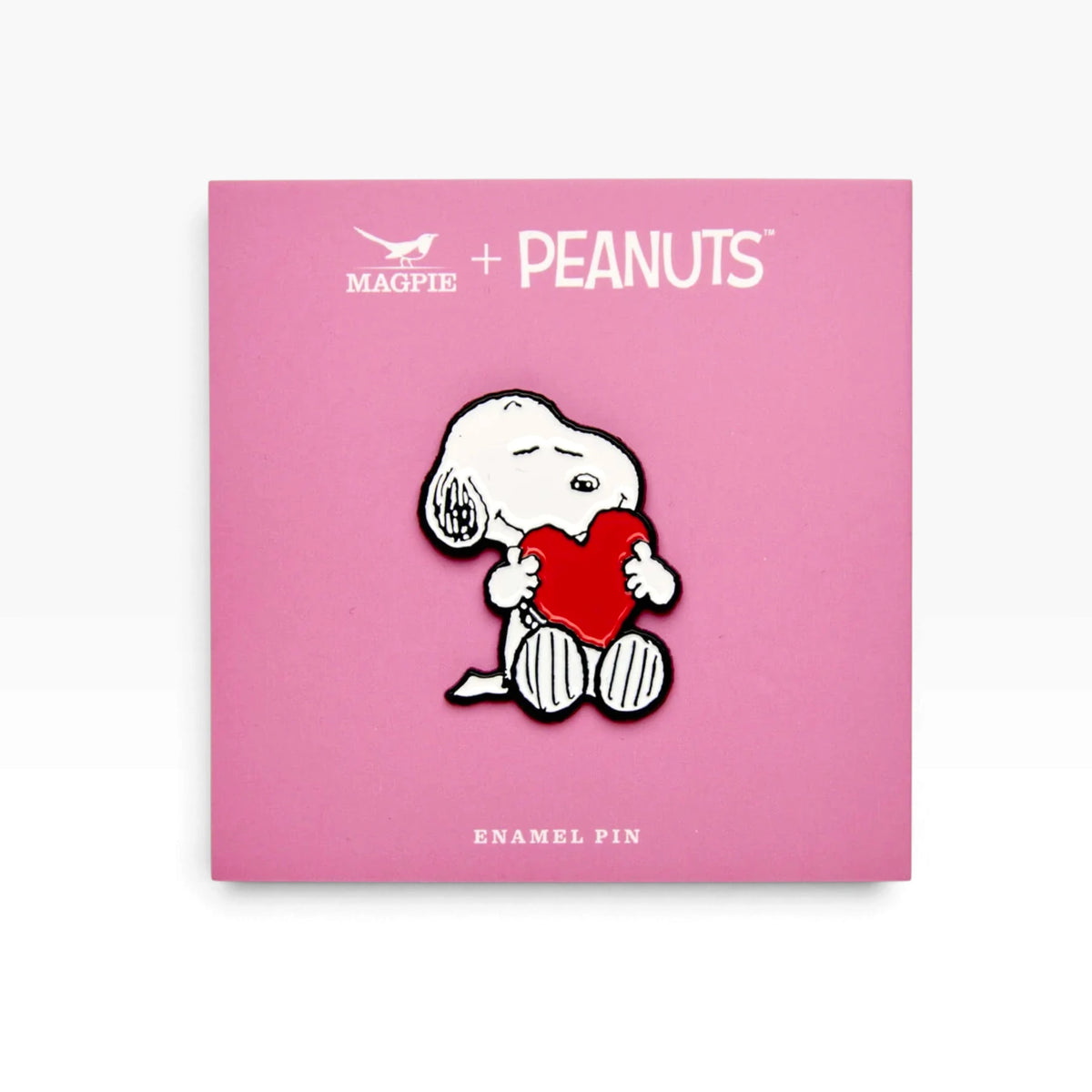 Snoopy love heart enamel pin on PEANUTS card, white dog holding a red heart