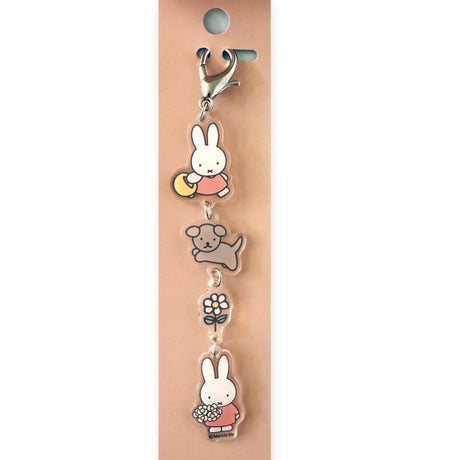 Add a touch of charm to your keys or bag with the Miffy & Snuffy Besties Bag Charm by Miffy, featuring cute cartoon charms—a bunny, dog, flower, and bunny holding a bouquet—all on a pink backing card.