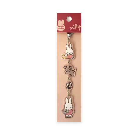The Miffy & Snuffy Besties Bag Charm by Miffy features four acrylic charms—Miffy, Snuffy, a dog, and a bear with a flower—on a pink branded backing card. A cute accessory, perfect for fans to use as a bag charm.