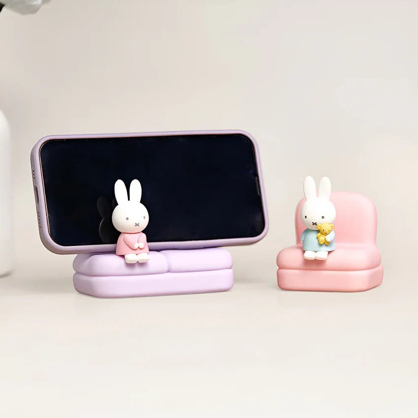 Phone stand sofa set with two rabbit figures on purple and pink seats