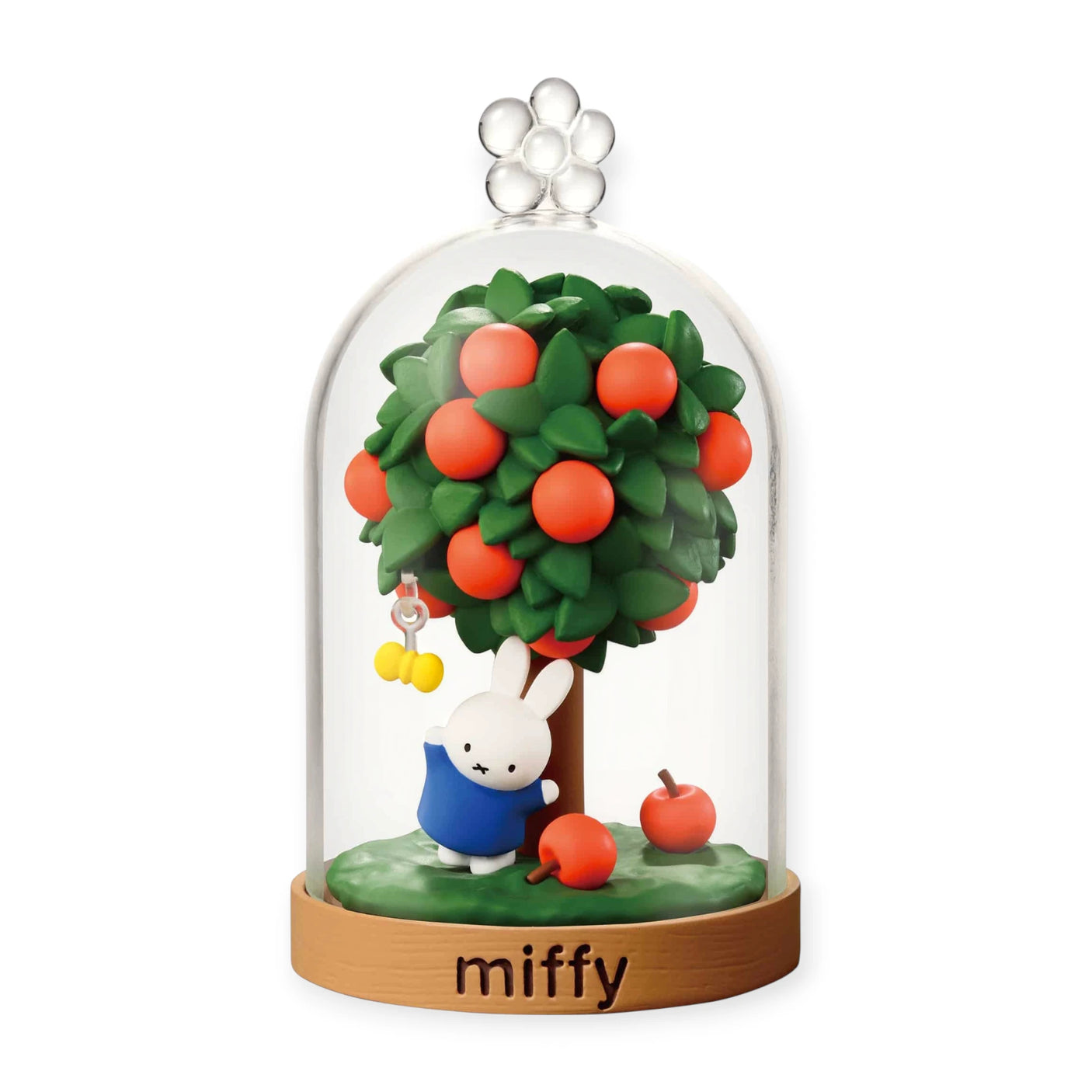 Miffy terrarium dome with green tree, red apples, and a blue rabbit figurine