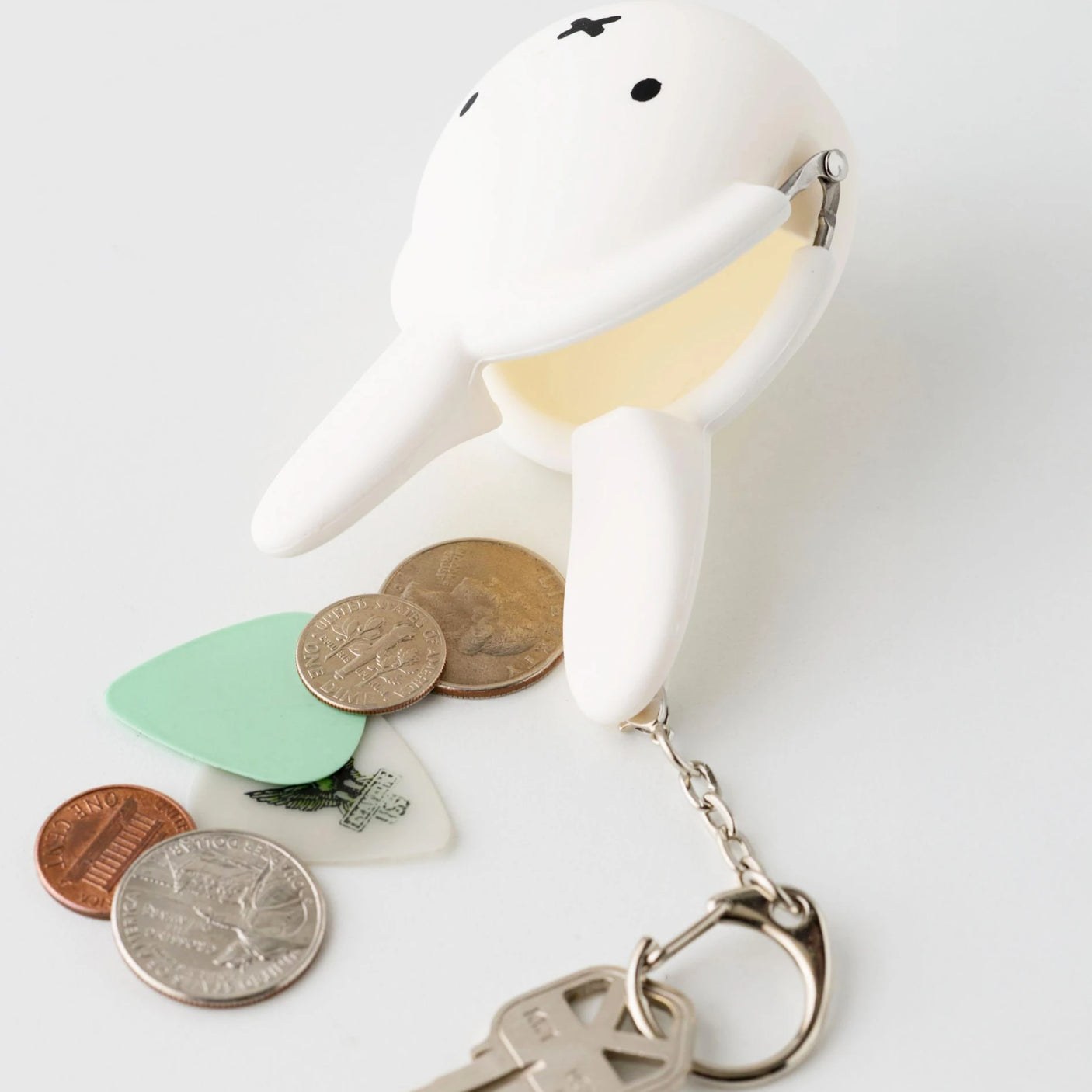 White Miffy keychain coin pouch made of soft silicone, holding coins and attached to a metal keyring.