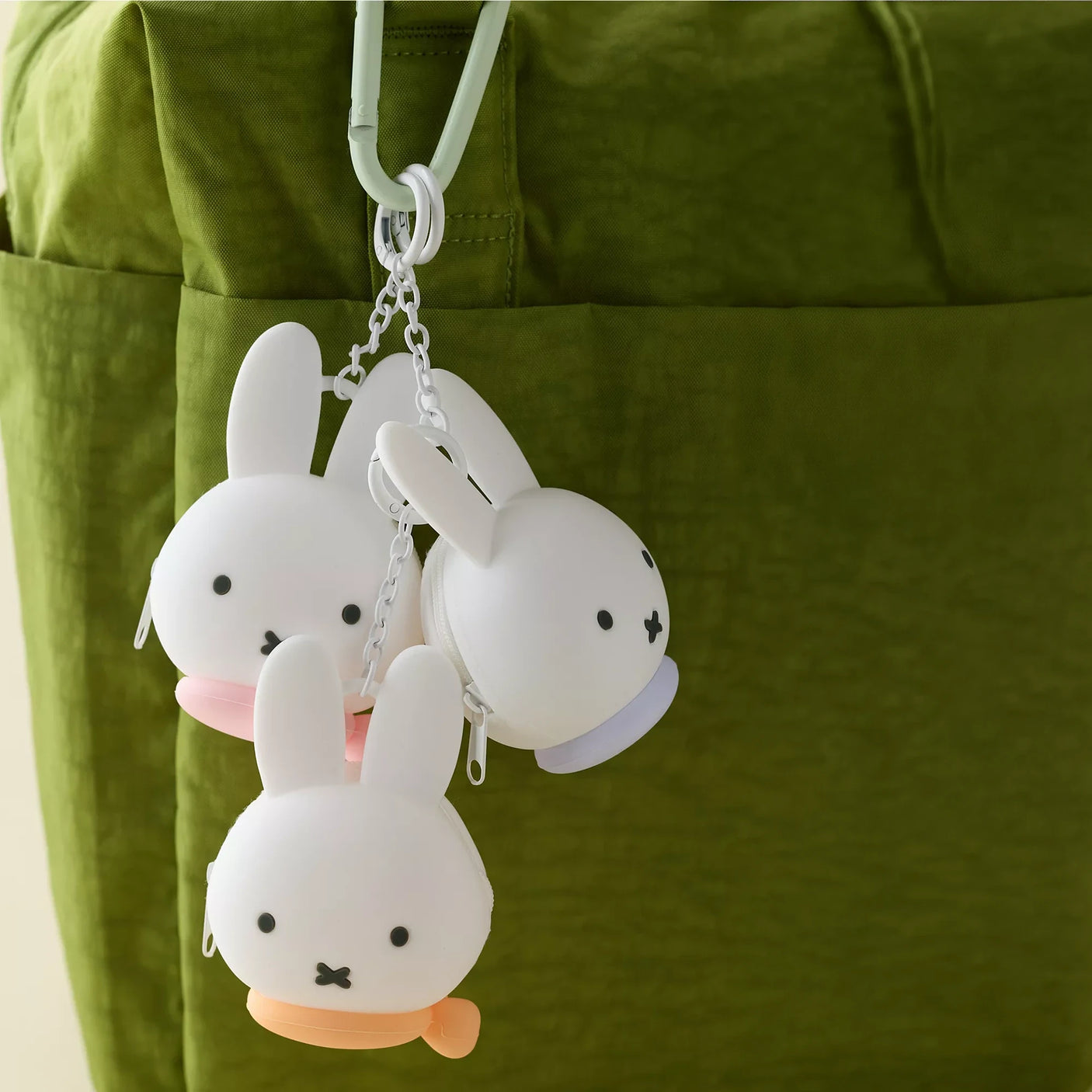 Miffy bunny coin pouch keychain, white plush bunny with key ring and chain, pink paw detail.