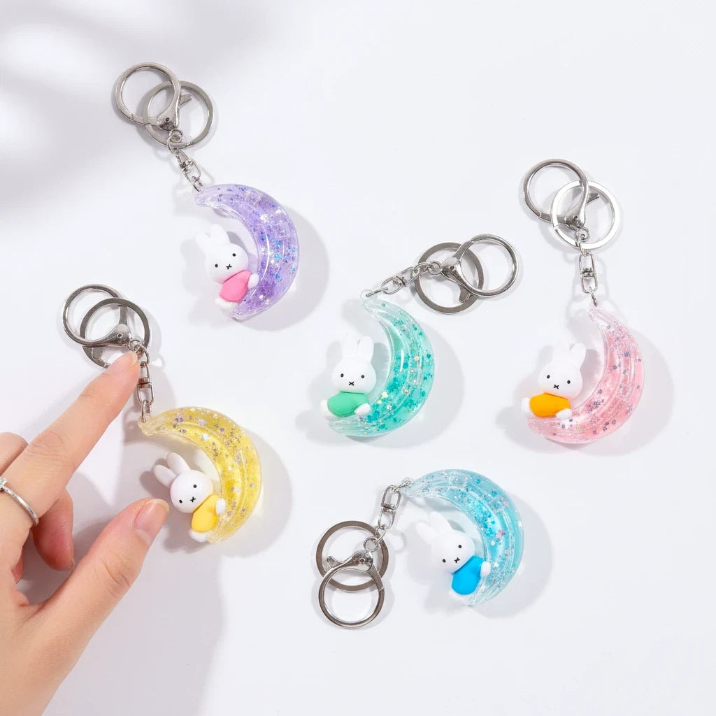 Rabbit moon keychain charms in pastel colors with silver rings, multiple styles shown