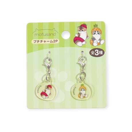 The Mofusand Mini Keychain Charm - 2 Piece Set includes two cat-in-fruit costume charms. The backing card highlights the Mofusand brand and showcases all three adorable designs in the collection.