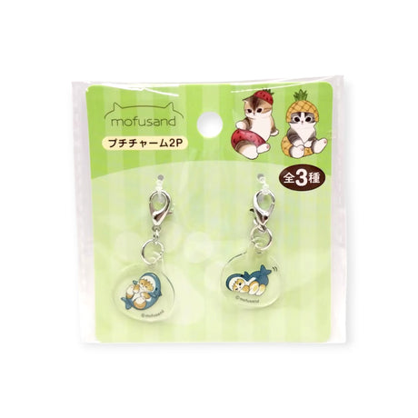 The Mofusand Mini Keychain Charm - 2 Piece Set features adorable fruit-themed cat charms, perfect for decorating bags or keys. Packaged with cute illustrations and Mofusand branding on a green background.