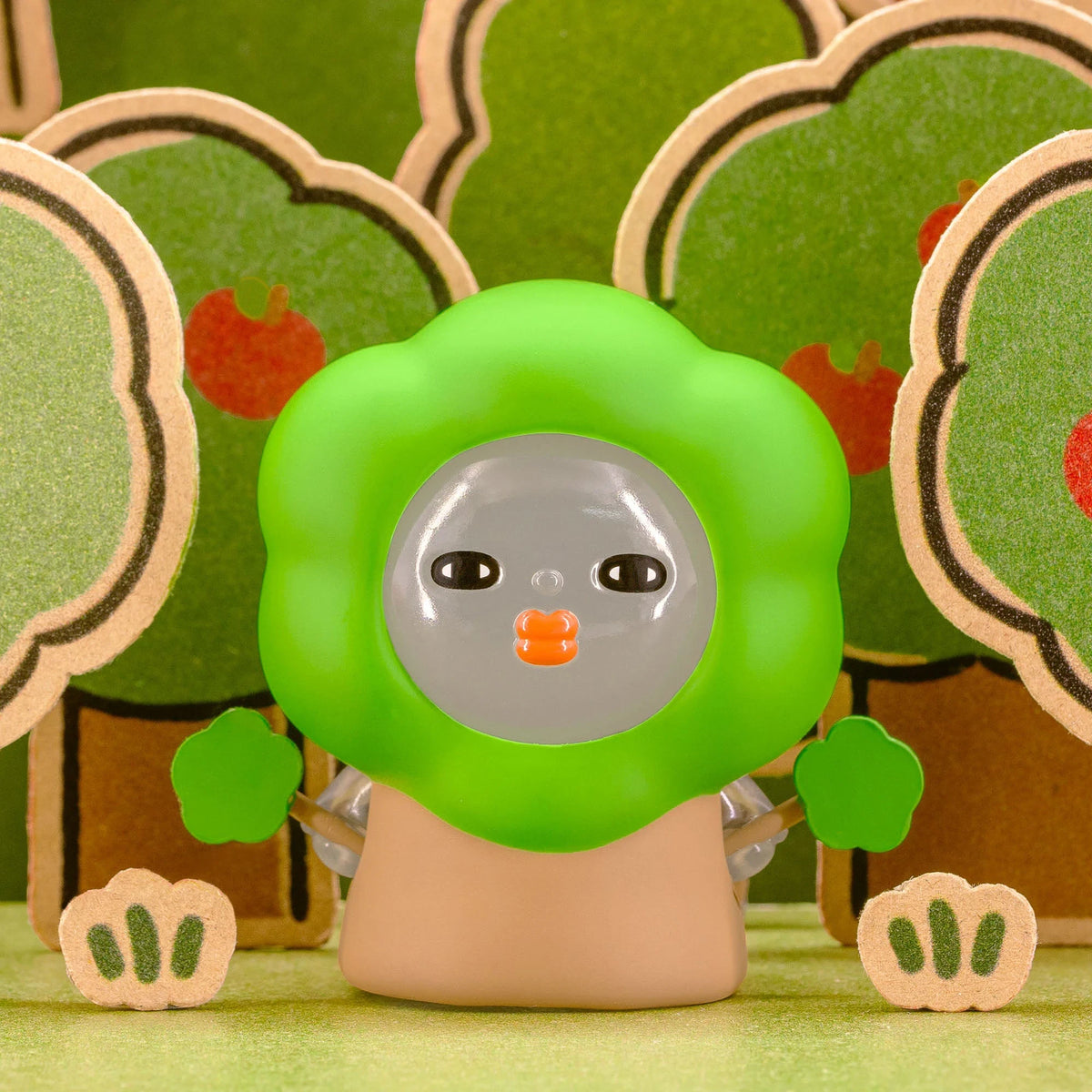 Green-hood blind-box figurine with clear face bubble and orange nose detail.