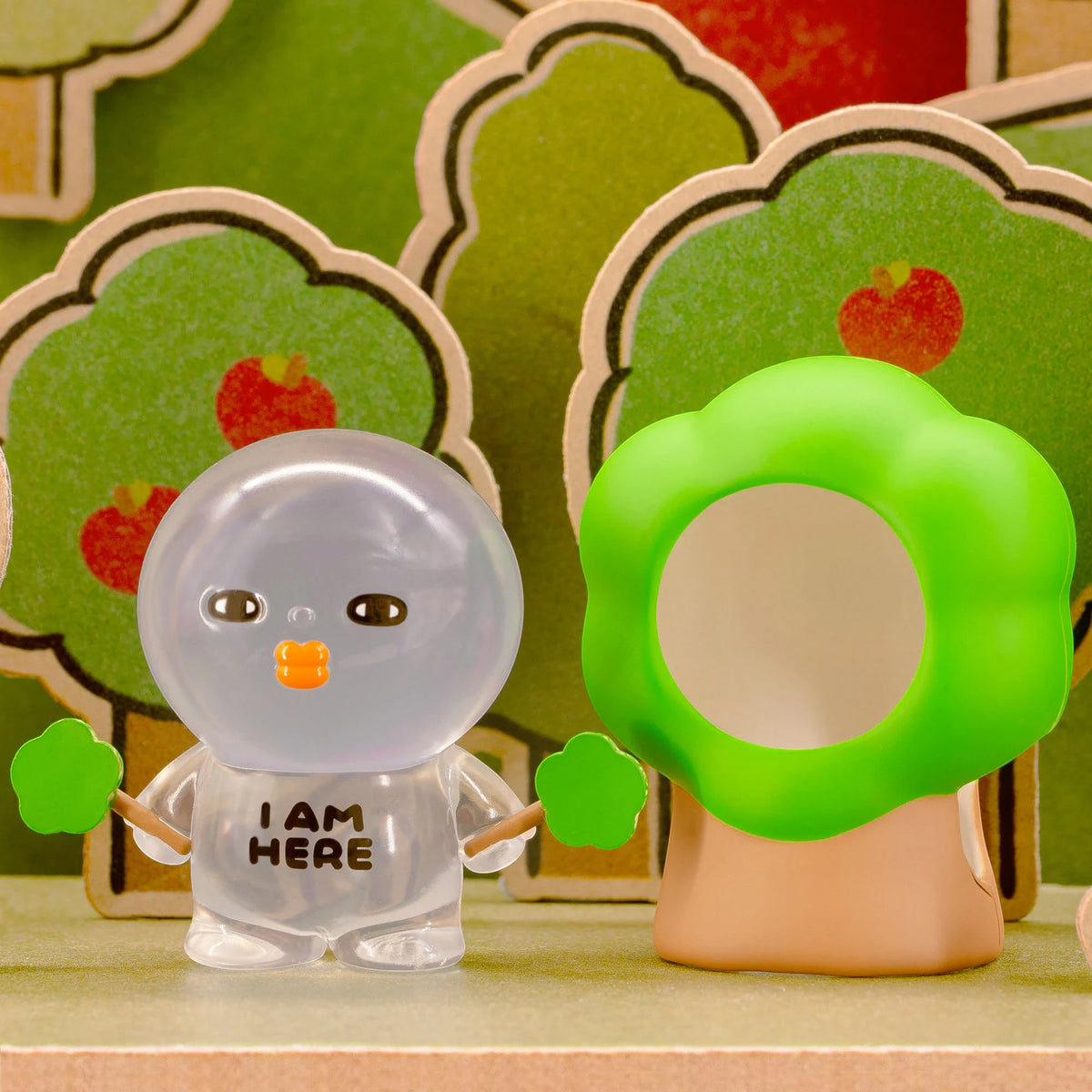Clear-sleeve blind-box figurine with dark eyes, orange badge, and gray cap.