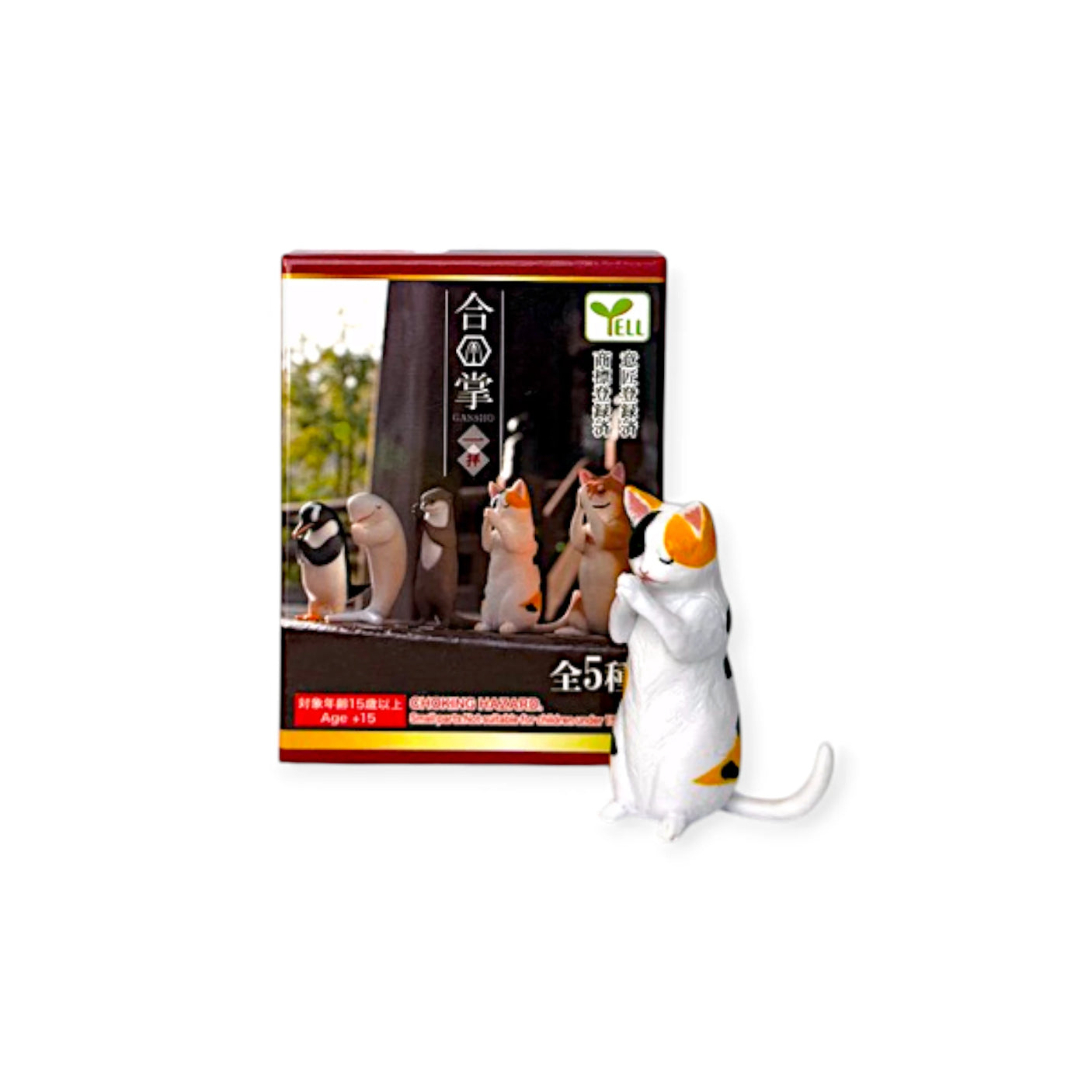 A small white and orange cat figurine stands next to the Yell Praying Animals Blind Box, which displays five spiritual animal figures in martial arts poses, each featuring unique accessories.