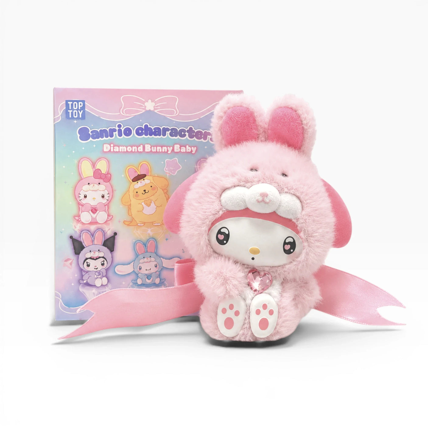Plush bunny keychain in pink outfit with bunny-ear hood, shown in product packaging.