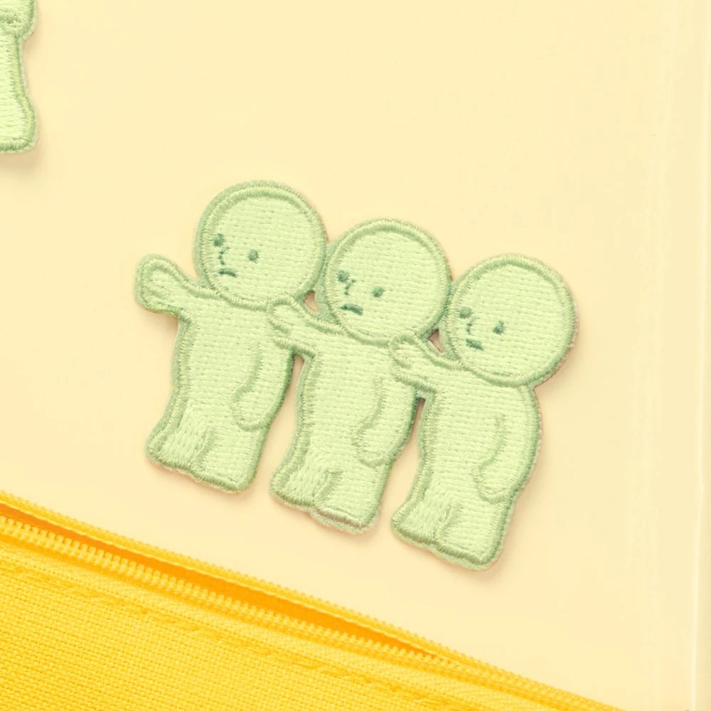 Light green embroidered character patch with three stacked cute faces and stitched details