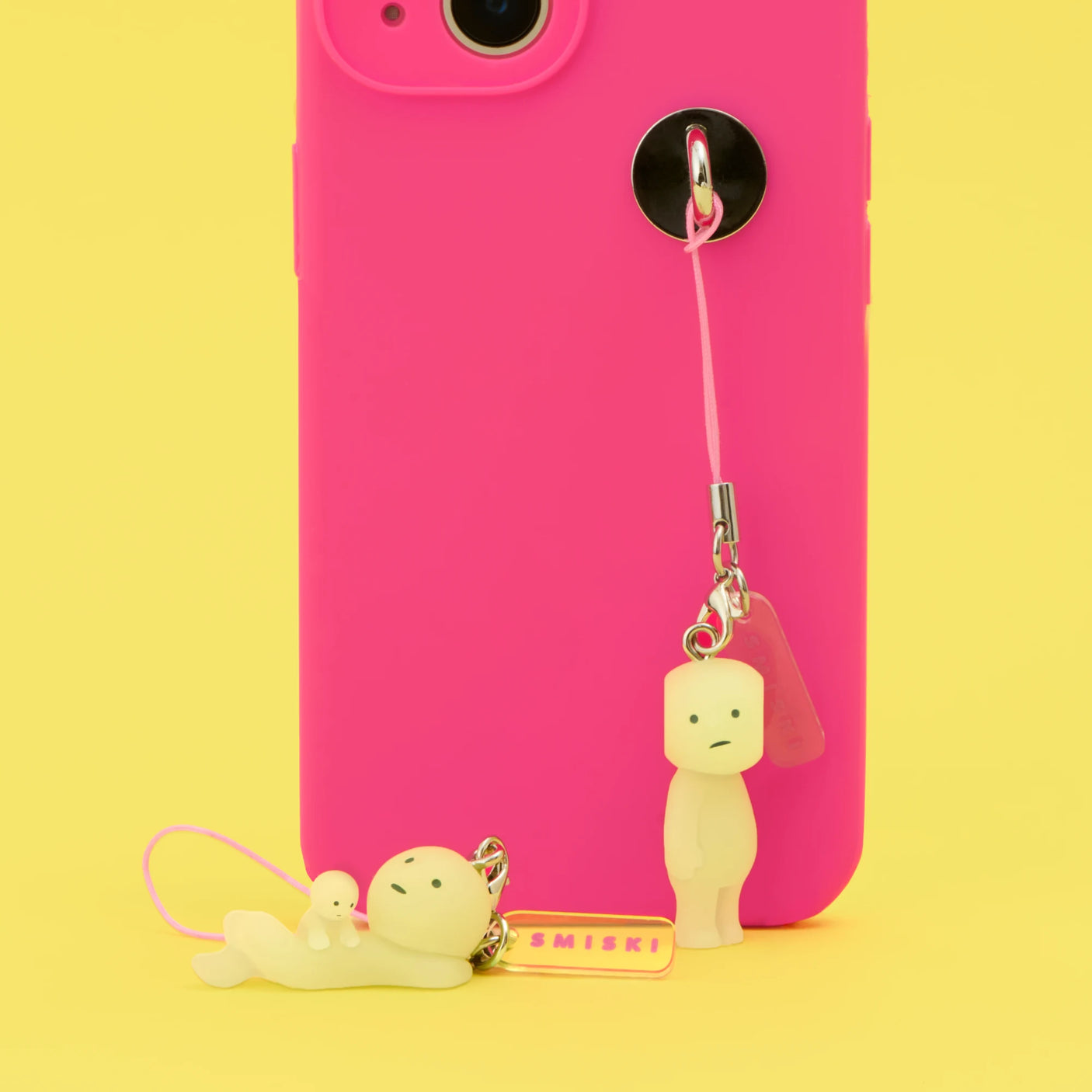 Smiski strap keychain with pink cords, metal rings, and small yellow character charms