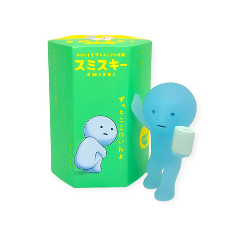 A photo showing a blue Smiski figure from the Bath Series, capable of glowing, holding a toilet roll. It is displayed next to its Blind Box packaging.