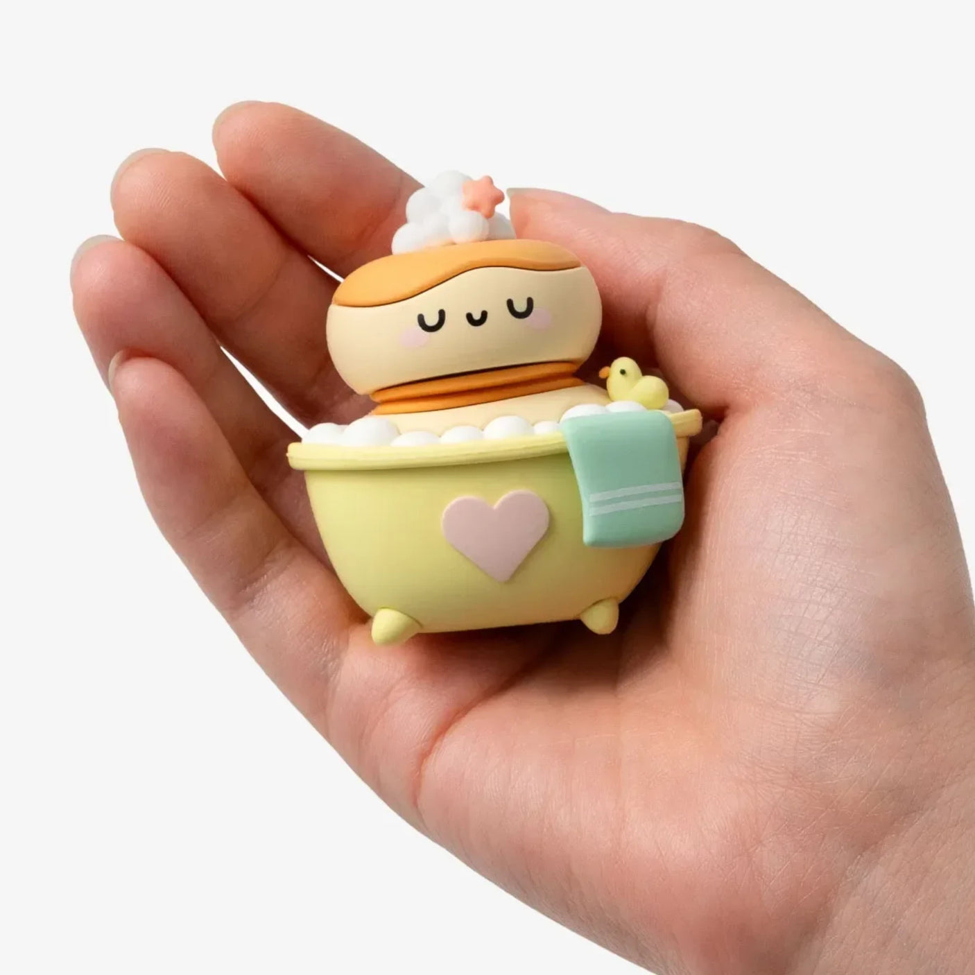Smoko Friends Bathroom Blind Box figure of a character relaxing in a yellow heart-decorated tub with bubbles and towel
