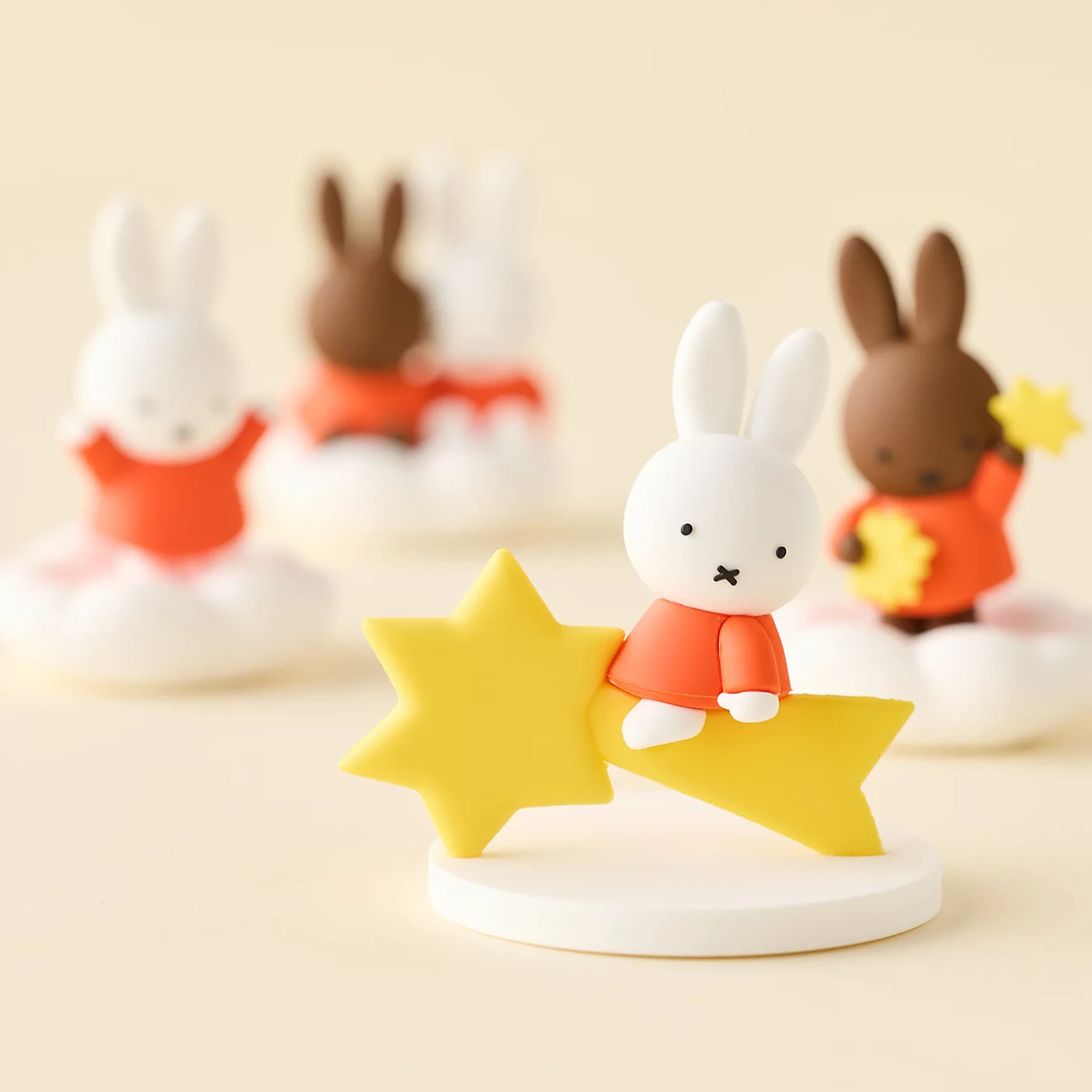 Rabbit blind box figure with orange outfit and yellow star on white crescent base