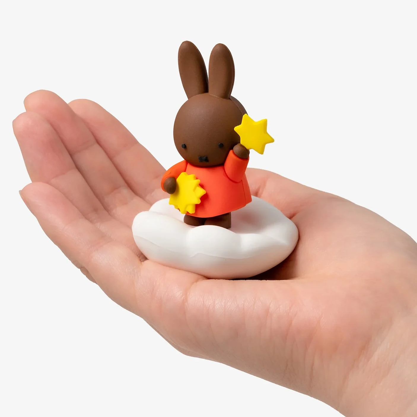 Rabbit blind box figure on cloud base with star held in orange outfit