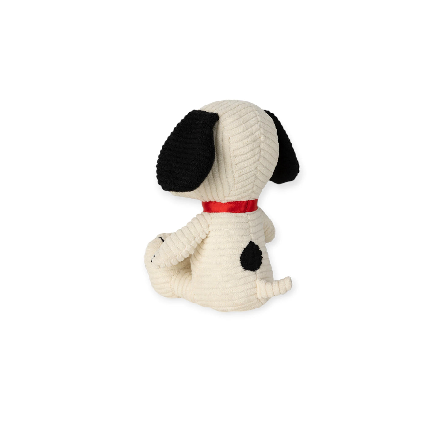 The Snoopy Corduroy Mini Plush (12cm) by Snoopy features cream fur, black ears, a black spot on its back, and a red collar. The plush dog is sitting and facing away from the camera.