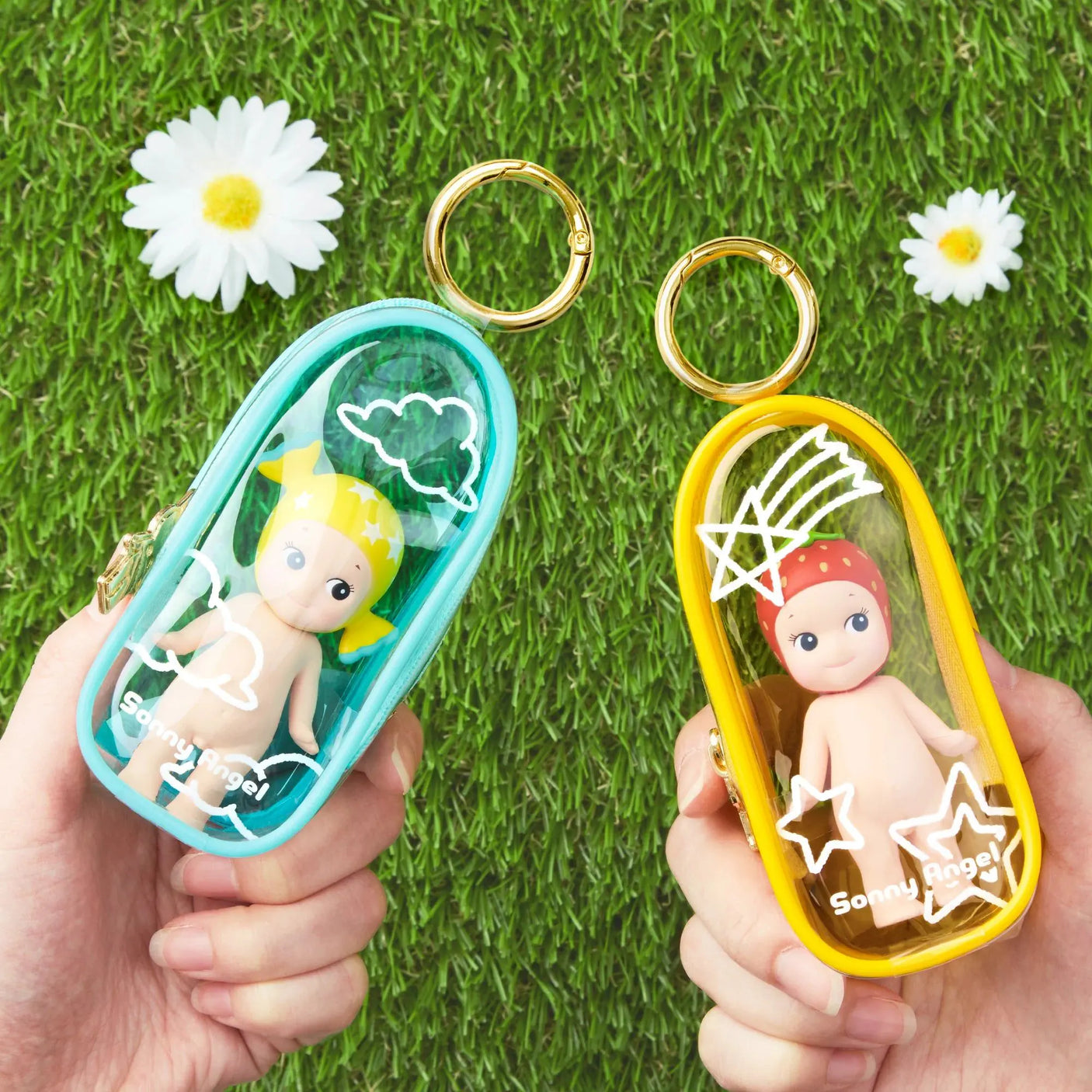 Sonny Angel My Bestie cases: blue and yellow transparent keychain pouches in hands