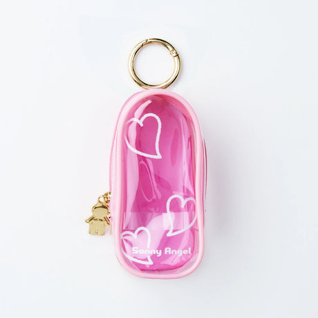 The Sonny Angel My Bestie Case - Pink is a small, pink, transparent zippered pouch with white heart designs, a gold keyring, and "Sonny Angel" printed on the front.