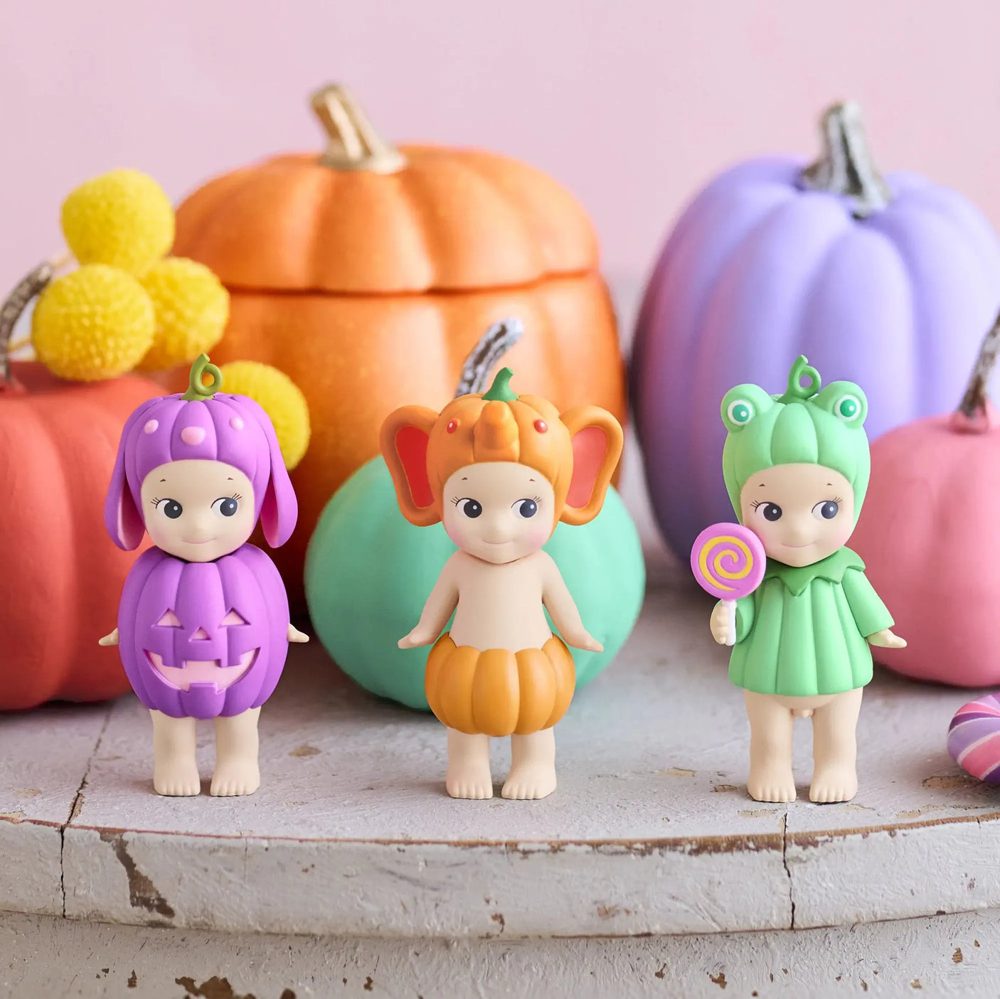 Three pumpkin patch mini figurines in blind box style: purple bunny, orange cat, green frog