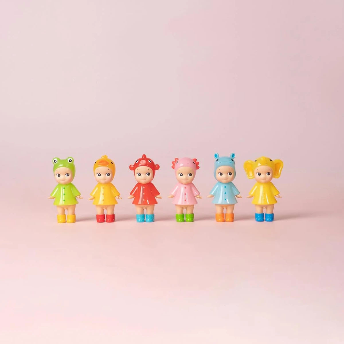 Six Sonny Angel Rainy Day Blind Box - Limited Edition dolls by Sonny Angel wear cute animal-themed rain outfits, standing in a row against a light pink background—a perfect collector's set for fans of Blind Box surprises.
