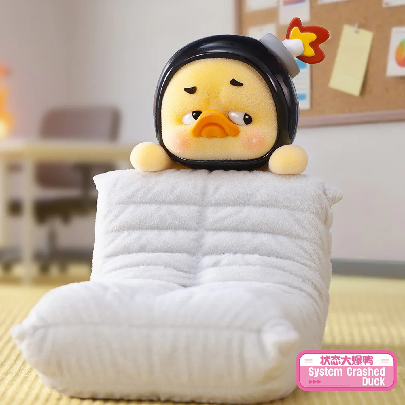 Upset Duck Blind Box - Status Display showing a yellow duck in a black helmet resting on a white cushion by Upset Duck